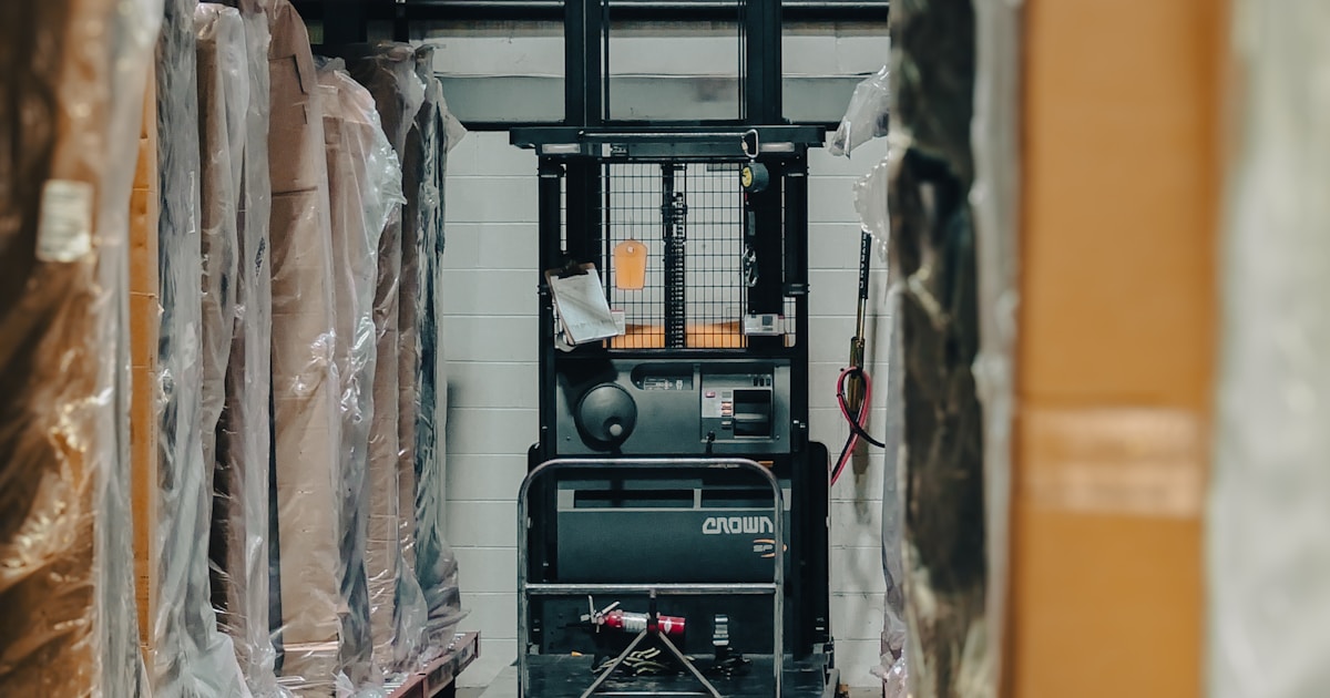 Aramex branded delivery van parked outside a warehouse with ecommerce packages being loaded