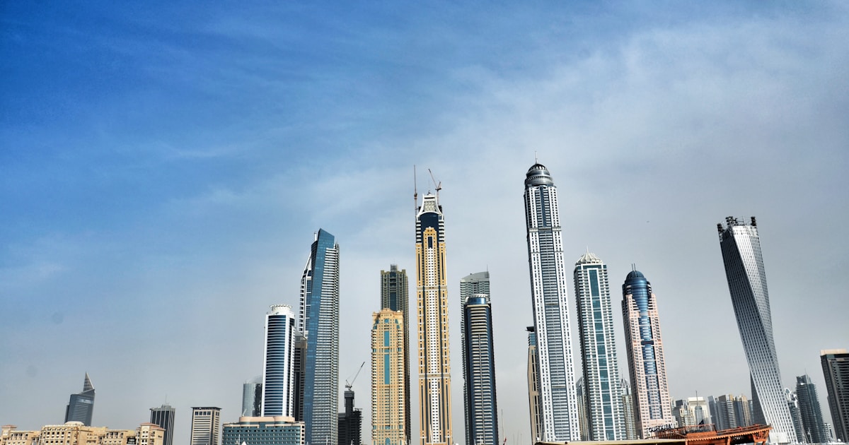 Courier delivery rider on motorcycle navigating Dubai streets with ecommerce packages